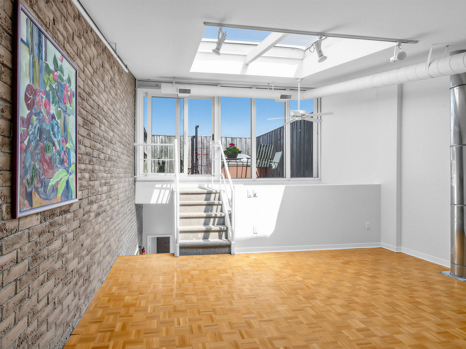 Exposed brick walls and soaring ceilings in the open-concept living space